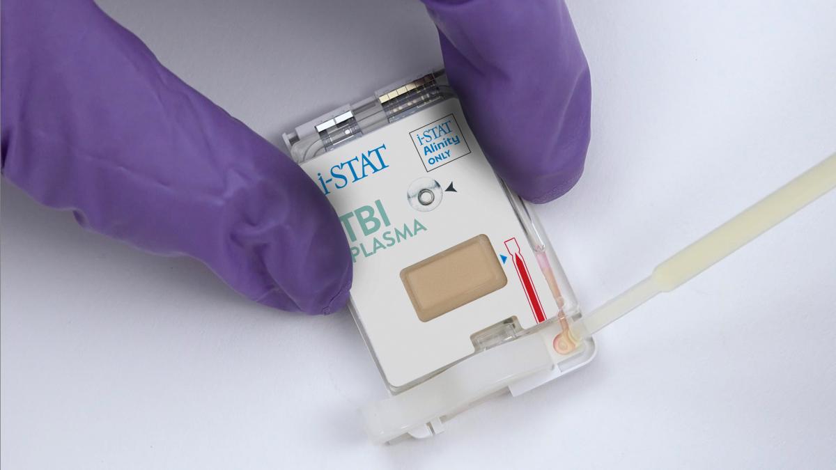 The new portable blood testing device uses a blood plasma sample that is inserted into a cartridge into the handheld device, which then analyzes it for proteins that indicate concussions. (Credit: Abbott)