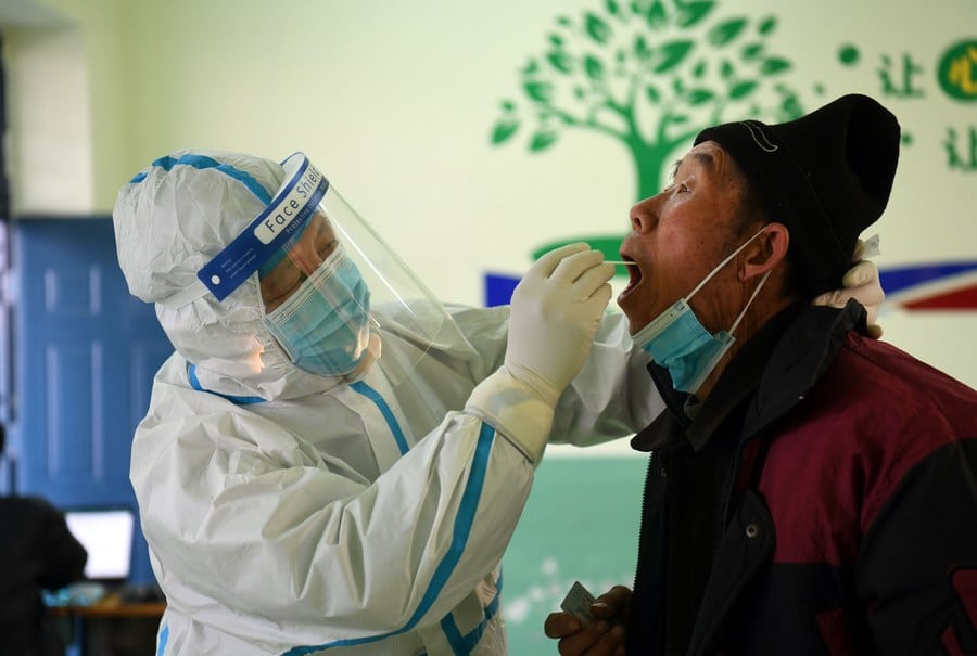 A medical worker collects a swab sample from a resident at a COVID-19 testing site in Baiwangzhuang Village of Jingxing County, Shijiazhuang, capital of north China's Hebei Province, Jan. 20, 2021. (Credit: Xinhua/Jin Liangkuai)