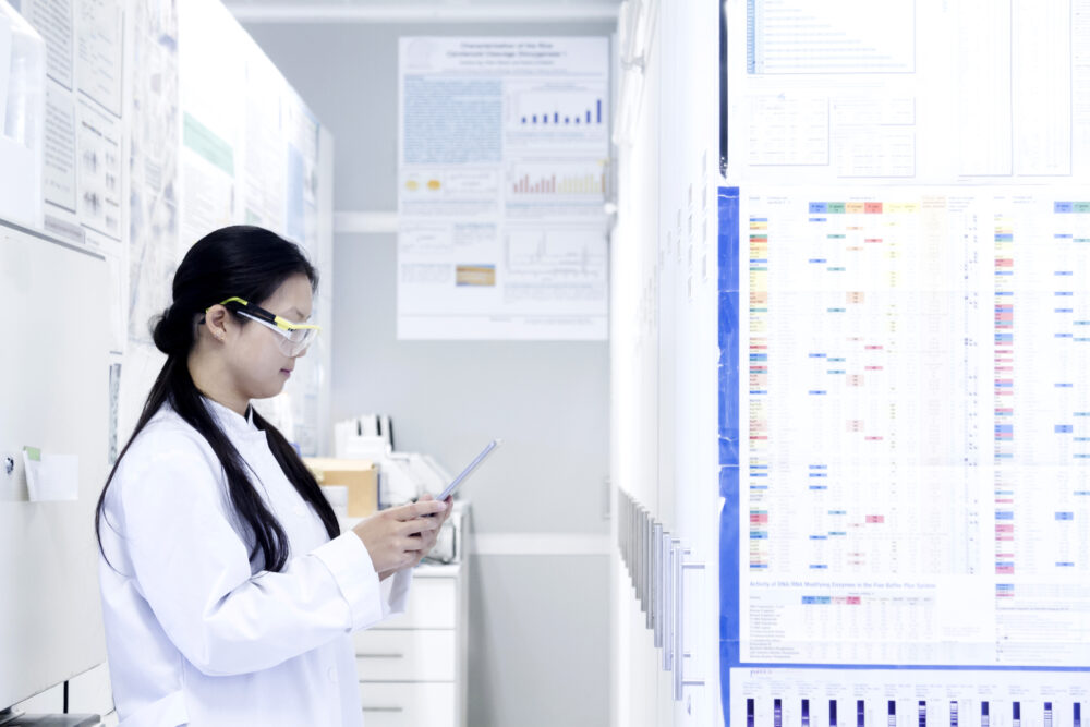 Analyzing data in a lab report. Image via Envato.