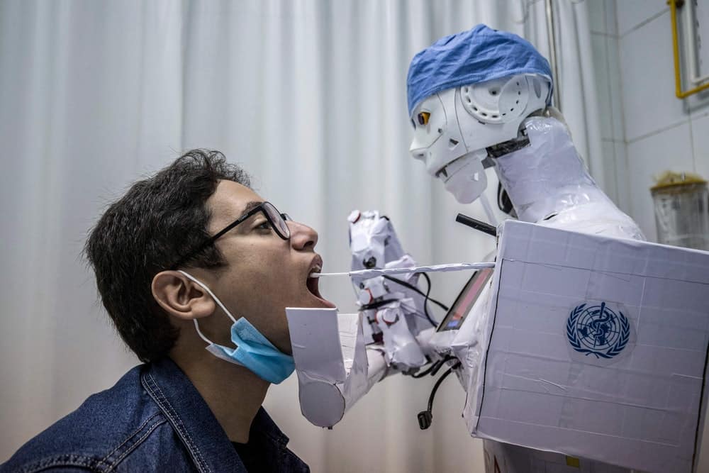 A robot collects a throat swab sample at a private hospital in Egypt. (Credit: KHALED DESOUKI/AFP via Getty Images)