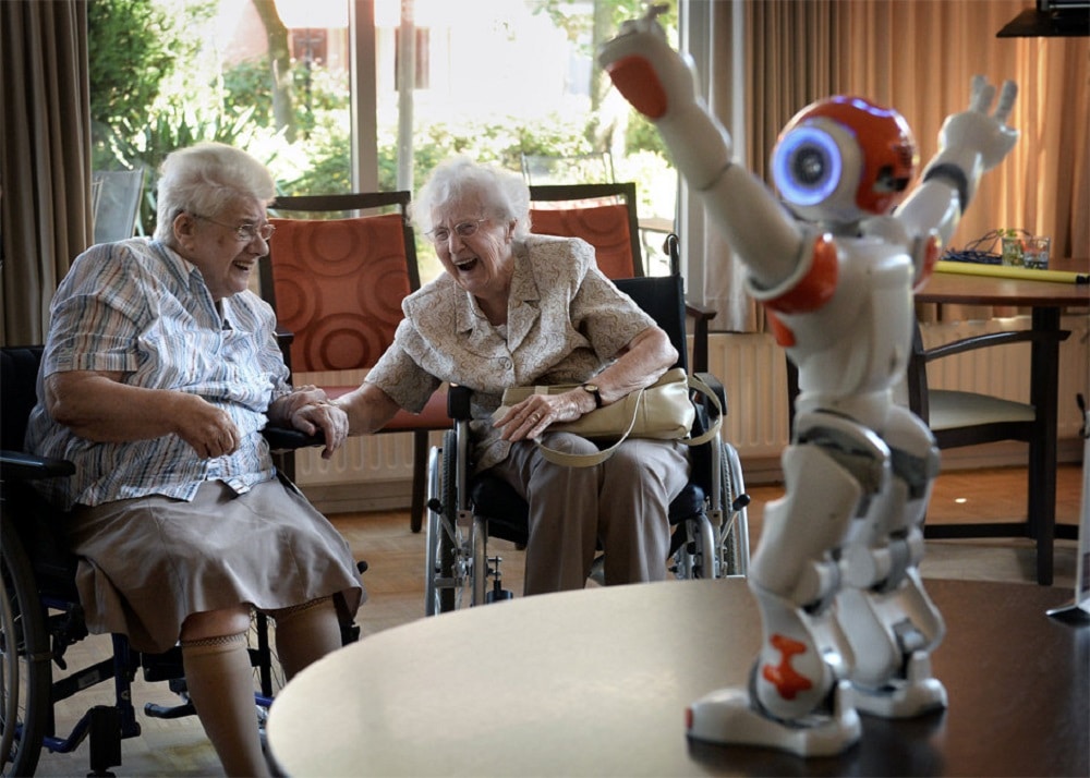 “Then all of a sudden little NAO arrives, waddling and singing old songs, and the elderly person’s face lights up.” (Credit: AFP)